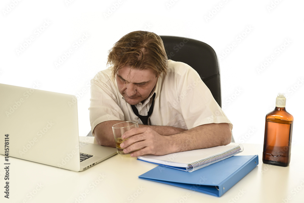 wasted messy alcoholic businessman drinking whiskey working at laptop computer desk at office wasted messy alcoholic businessman drinking whiskey working at laptop computer desk at office