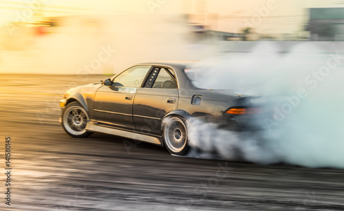 Fotografiet Motion automobile blur, Auto vehicle race car drift racing on speed track with lot of smoke tire burn