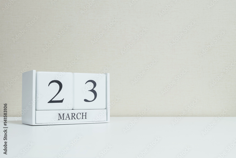 Closeup white wooden calendar with black 23 march word on blurred white wood desk and cream color wallpaper in room textured background with copy space , selective focus at the calendar Closeup white wooden calendar with black 23 march word on blurred white wood desk and cream color wallpaper in room textured background with copy space , selective focus at the calendar