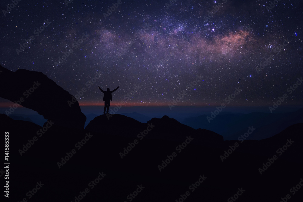 Fototapeta premium person is standing on the top of the hill