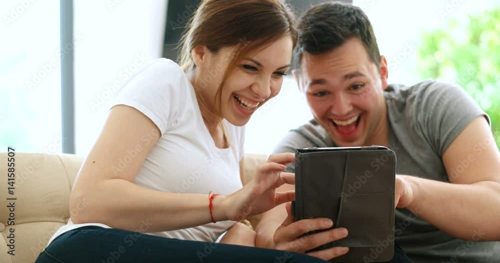 Young Couple using interent on digital tablet Young Couple using interent on digital tablet