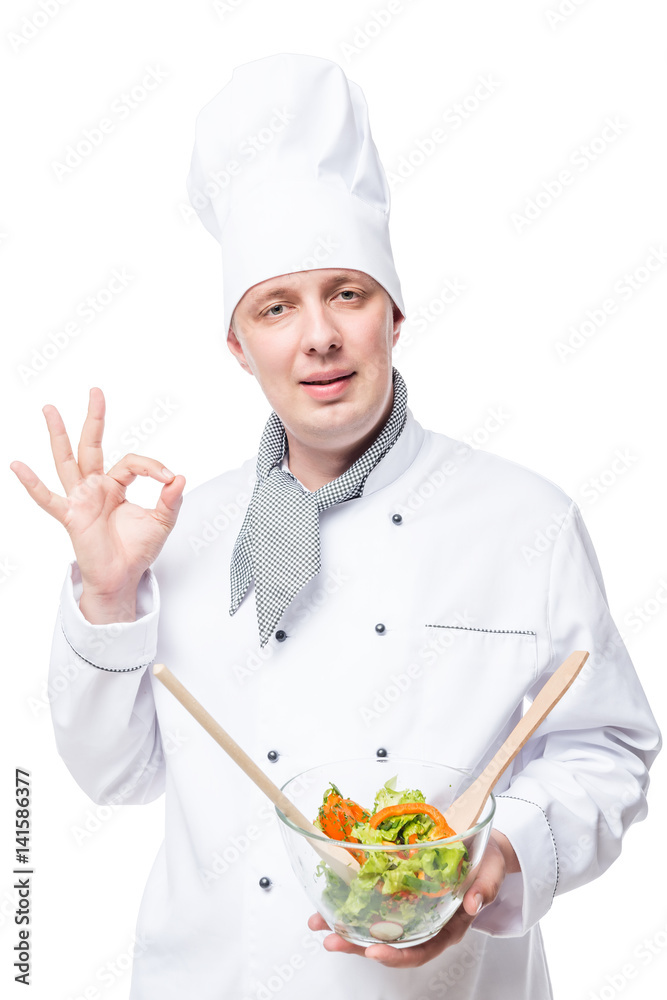 portrait of admiring chef with salad in hands showing hand gesture on a white background portrait of admiring chef with salad in hands showing hand gesture on a white background