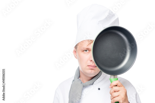 serious expression chef with an empty pan in the studio