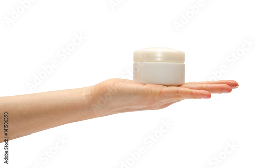 hand of young girl holding cream bottle.