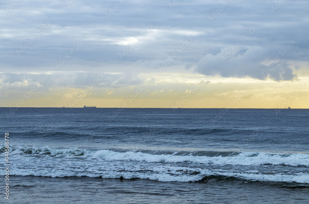 Morning Ocean Against Cloudy Sky with Ships on Horizon