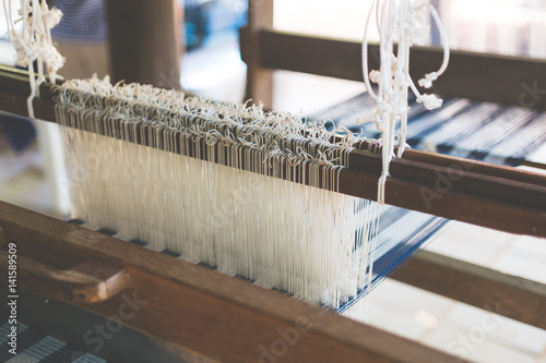 Indigo dyed thread in the loom photo