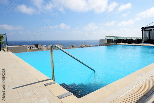 The swimming pool on the top of building of luxury hotel, Malta