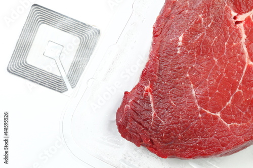 The fresh cow beef in food grade transparent packaging and rfid tag represent the food raw material and meat concept related idea.