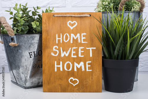 Wooden board with text home sweet home