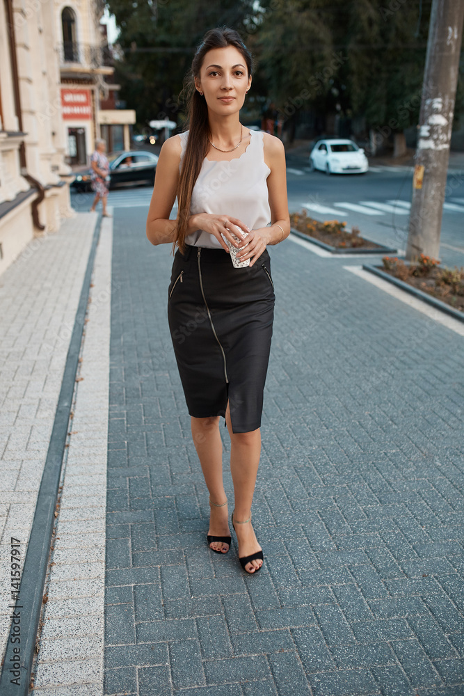 Fashion pretty woman walking through the streets of Old City Fashion pretty woman walking through the streets of Old City