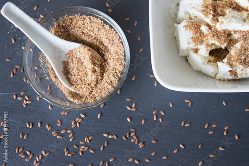 Schilderij op canvas Homemade cottage cheese cream with crushed flax seeds on stone background