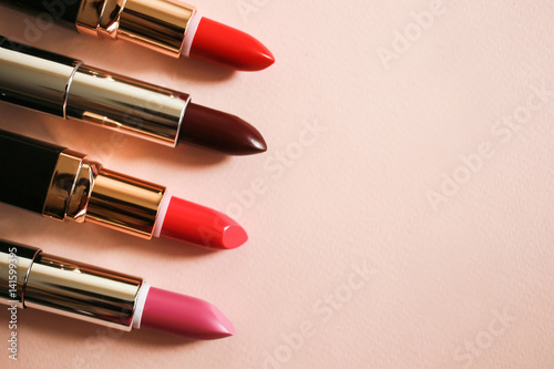 Set open lipsticks on a beige background