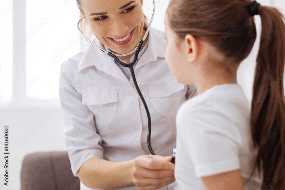 Sweet trained doctor consulting her little patient Sweet trained doctor consulting her little patient