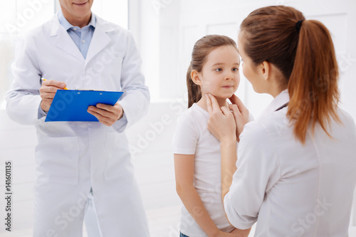 Trained pediatrician doing a checkup on little patient