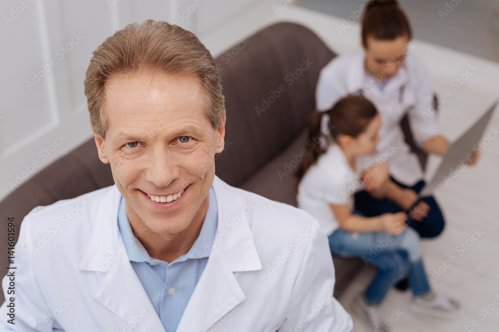 Fototapeta premium Charming competent pediatrician posing for a photographer