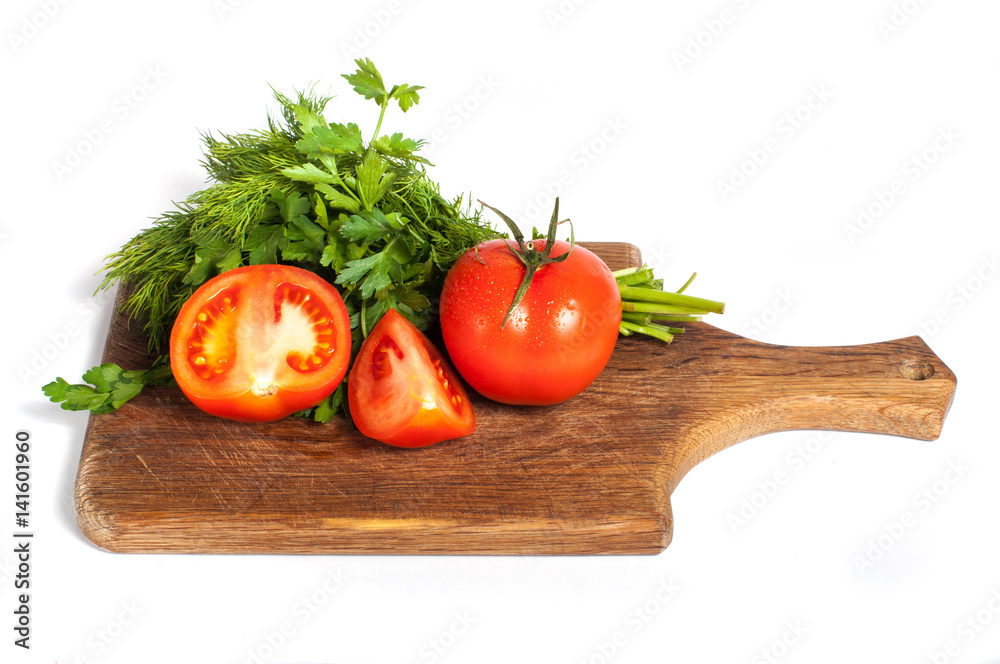 Red tomatoes with parsley on a wooden board Red tomatoes with parsley on a wooden board