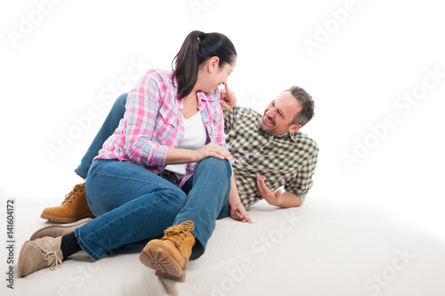 Happy man and woman sitting relaxed on floor