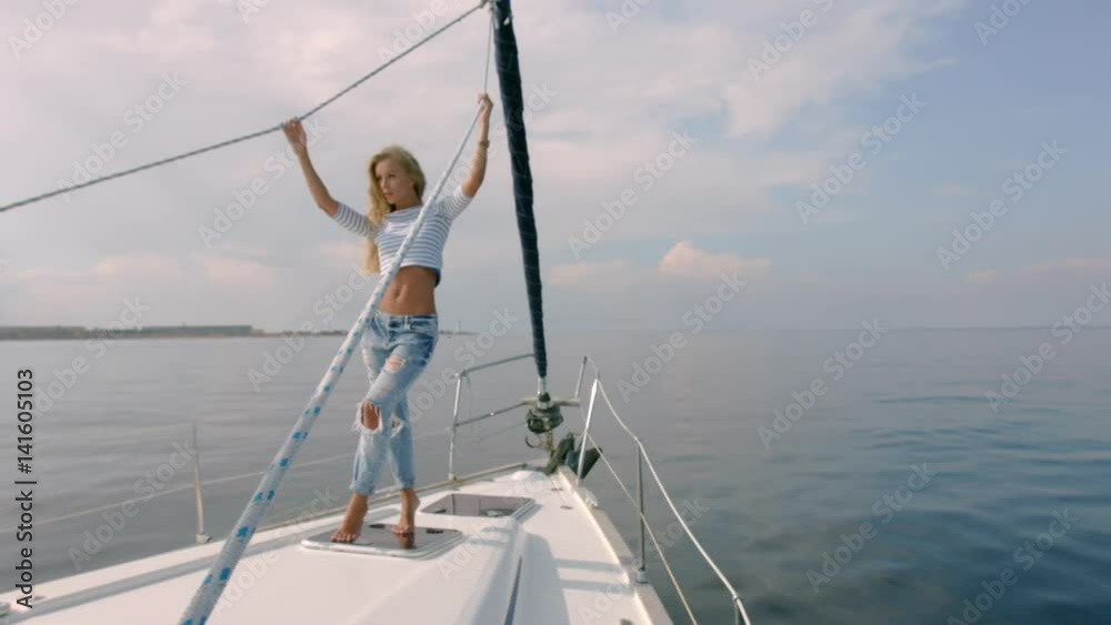 Young lady relaxing on the moving yacht in sea at sunny day Young lady relaxing on the moving yacht in sea at sunny day