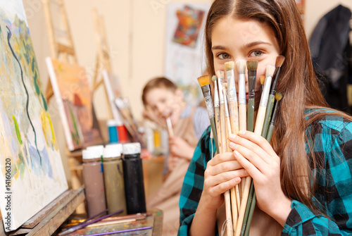 Positive kids having fun during the painting lesson