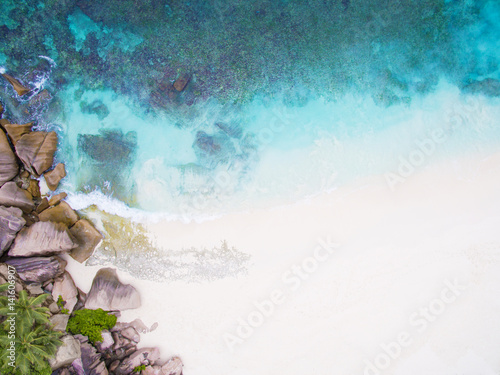 Seychelles Island white tropical paradise beach, turquoise sea and granite rocks aerial landscape. La Digue Grand Anse beach seascape. 