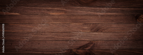 Dark brown scratched wooden cutting board. Wood texture background
