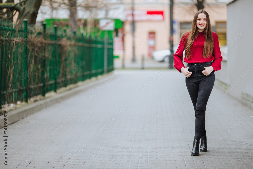 Young woman walking on the street background and smile