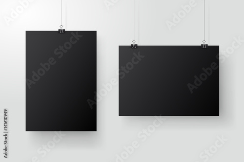 Black posters hanging on binder. Grey wall with mock up empty paper blank. Layout mockup. Vertical and horizontal template sheet