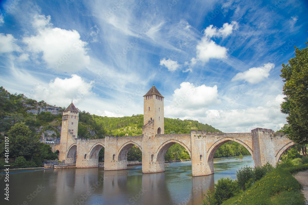 Summer view of medieval stone Valentre Bridge with blu sky in Cahors, France