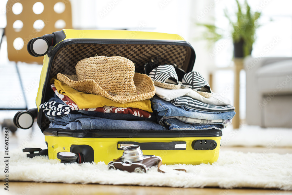 Preparation travel suitcase at home - obrazy, fototapety, plakaty 