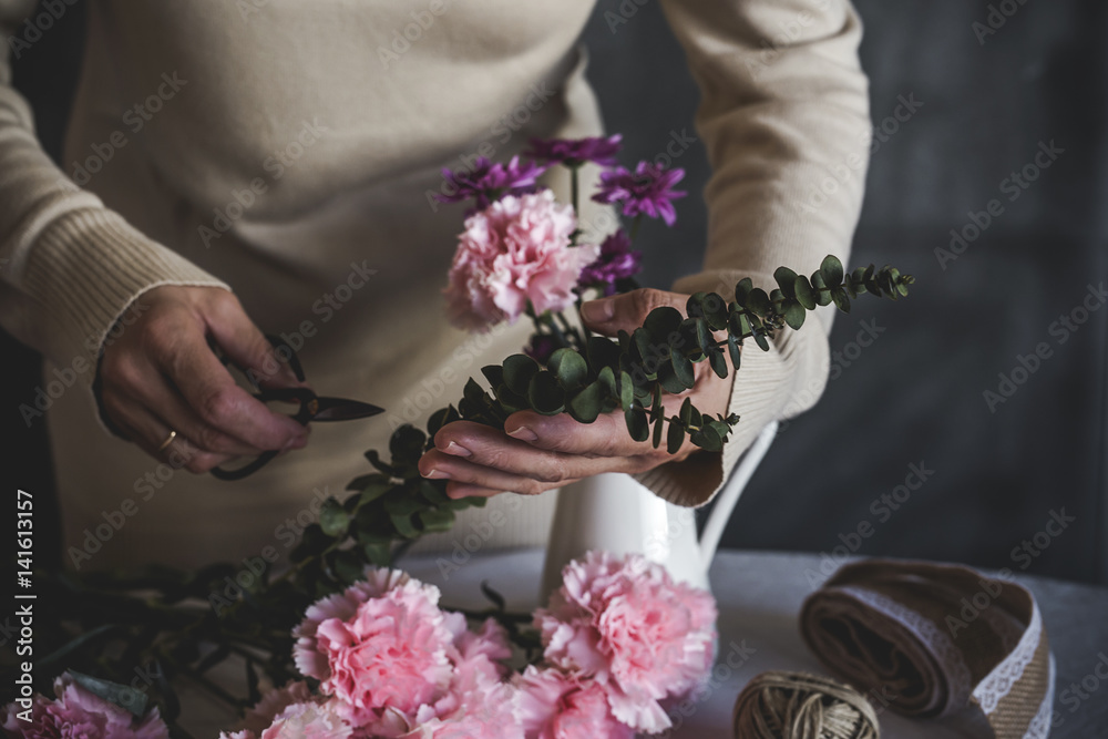 Graceful hands of the woman florist making bouquet of flowers Graceful hands of the woman florist making bouquet of flowers