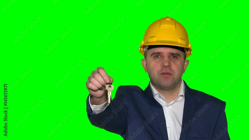business man or real estate agent with helmet show keys from new house or flat business man or real estate agent with helmet show keys from new house or flat