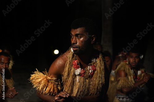 Fijian men dancing a traditional male dance meke wesi in Fiji
