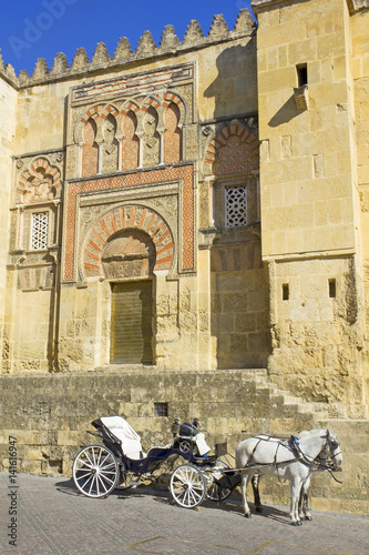 Horse carriage parked next to the mosque of Cordoba, Spain. Located in the Spanish region of Andalusia, Its structure is considered one of the most accomplished monuments of Moorish architecture