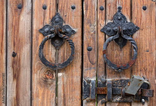 Dark brown wooden gate with iron locks