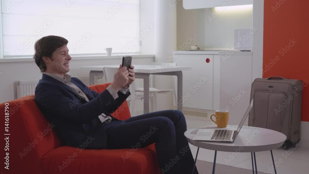 Young businessman in hotel room has video call with friend or girlfriend. Happy man using internet for phone conversation. Handsome manager in business trip. caucasian guy holding touch screen tablet Young businessman in hotel room has video call with friend or girlfriend. Happy man using internet for phone conversation. Handsome manager in business trip. caucasian guy holding touch screen tablet