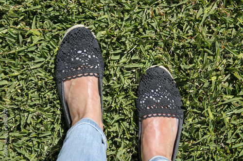 selfie suntanned female feet on green grass