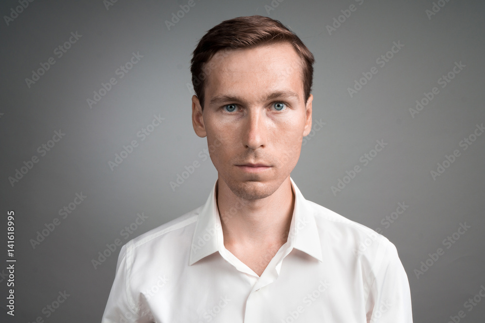 Business man in white shirt, portrait on grey background. Business man in white shirt, portrait on grey background.