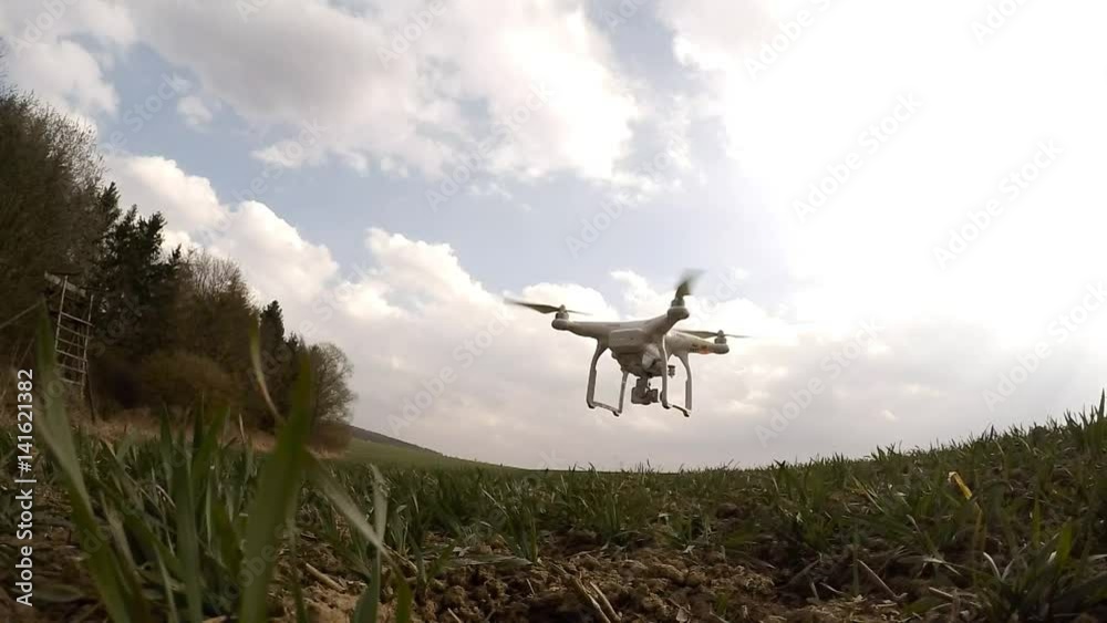 Drone flight over wheat field. Young seedlings in brown soil. New tool for farmers use drones to inspect of cultivated fields. Modern technology in agriculture. Drone flight over wheat field. Young seedlings in brown soil. New tool for farmers use drones to inspect of cultivated fields. Modern technology in agriculture.