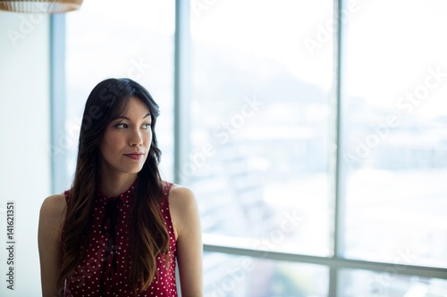 Free Download Thoughtful woman looking through window - GFXLoad