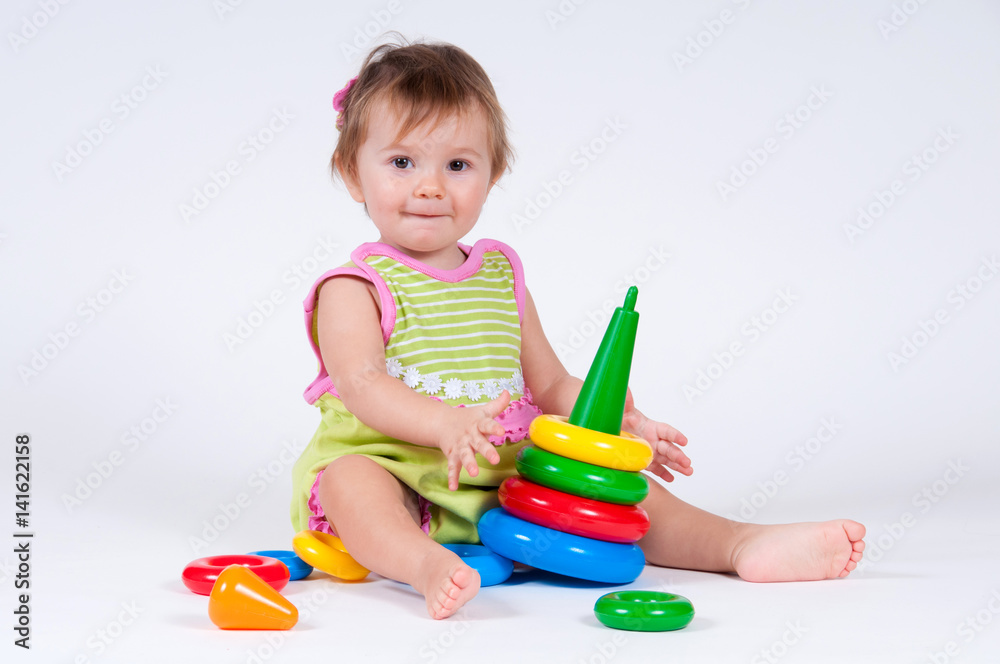 Cute little girl playing with a toy pyramid Cute little girl playing with a toy pyramid