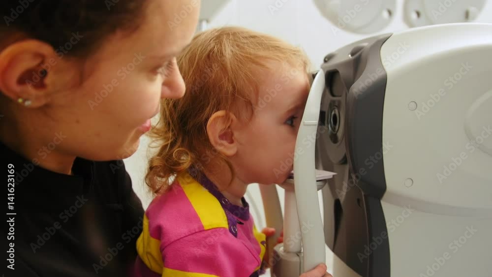 Children ophthalmology - optometrist Checks Child's Eye Children ophthalmology - optometrist Checks Child's Eye