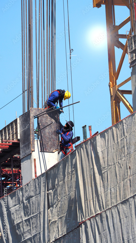 Two workers on the construction site.