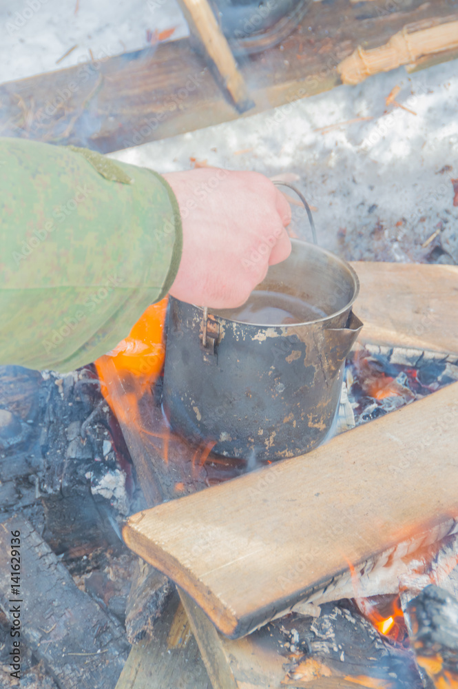 camping pot heated over the fire.NEF camping pot heated over the fire.NEF