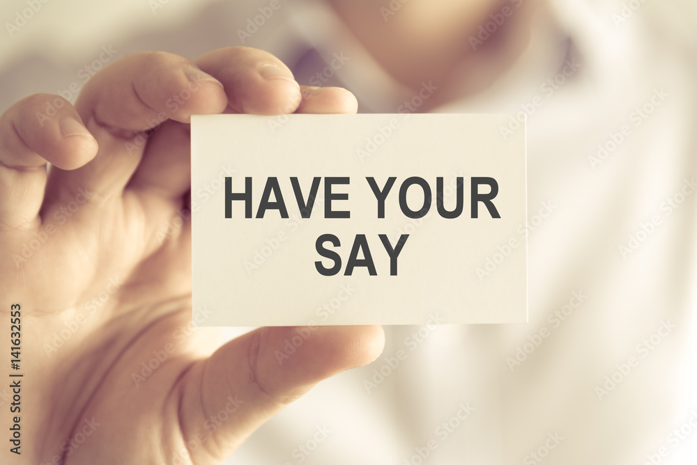 Businessman holding HAVE YOUR SAY message card