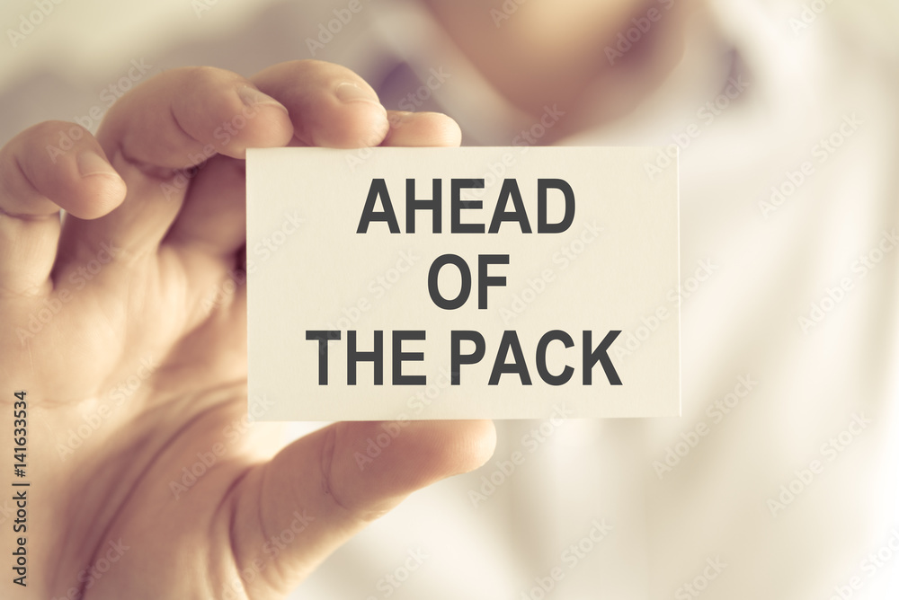 Businessman holding AHEAD OF THE PACK message card Businessman holding AHEAD OF THE PACK message card