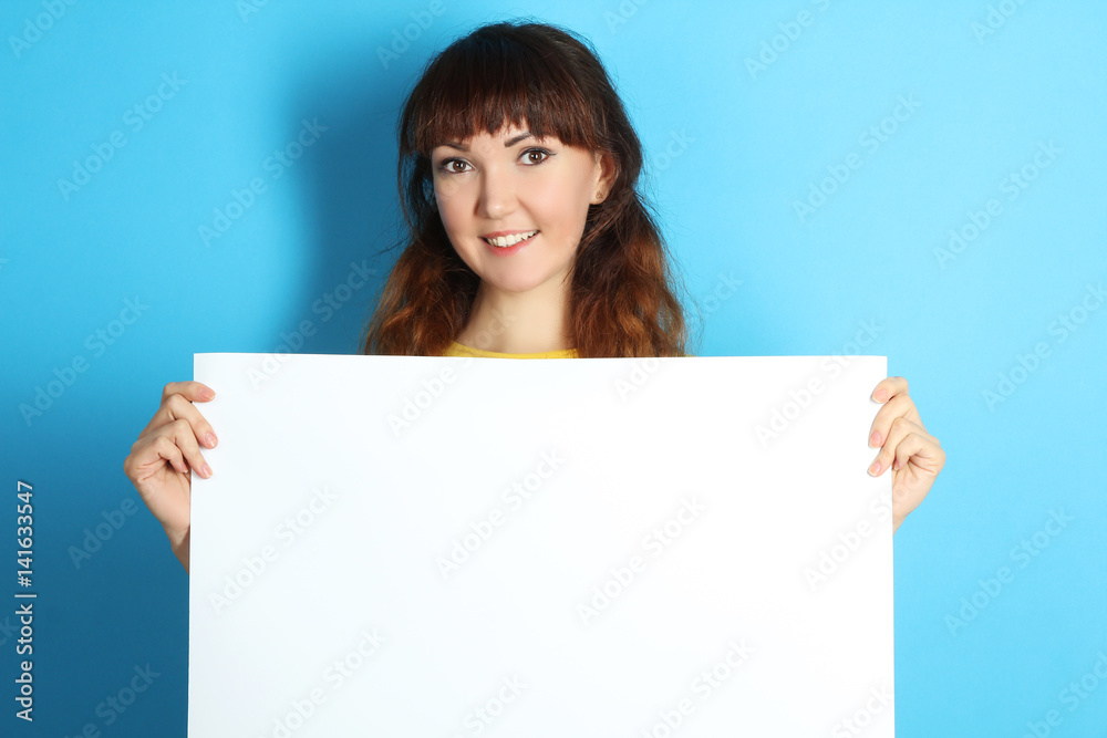 girl holding a big white sheet of paper girl holding a big white sheet of paper