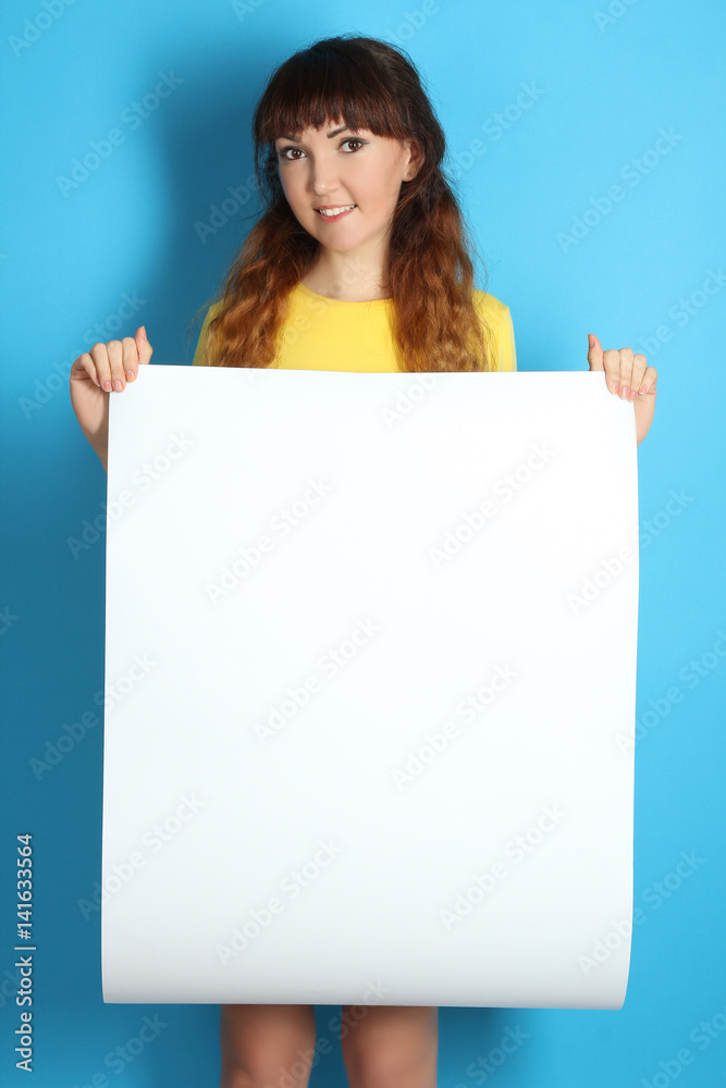 girl holding a big white sheet of paper Stock Photo
