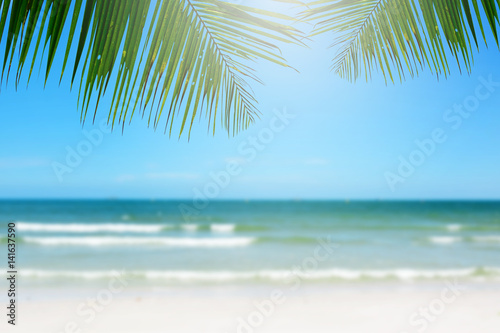 Beach background with palm tree. © Ubonwan