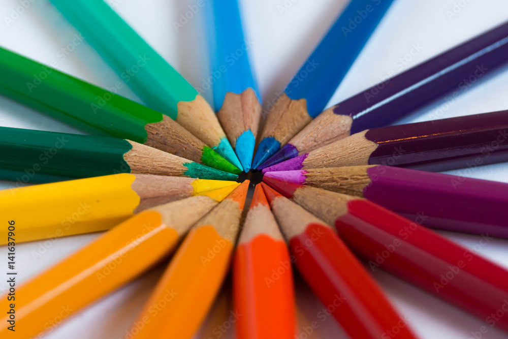 Many different colored pencils put in circle on a white background. Colored pencils rainbow. Many different colored pencils put in circle on a white background. Colored pencils rainbow.