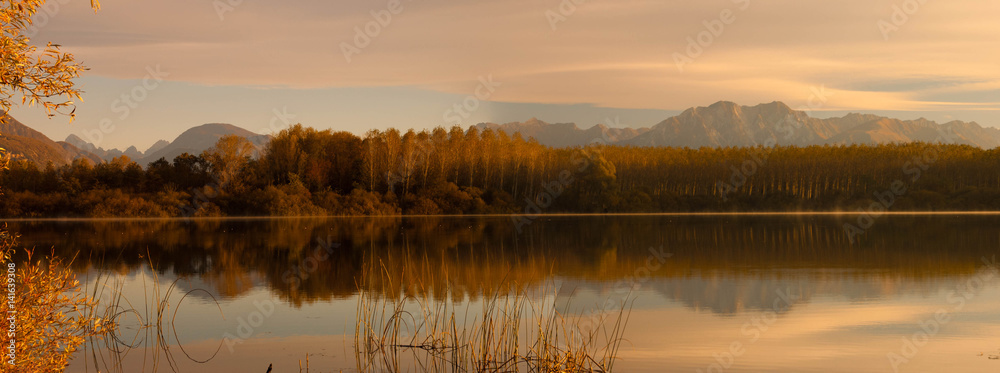 Trees reflected in the lake of Ragogna, Italy. Autumn colors. Trees reflected in the lake of Ragogna, Italy. Autumn colors.